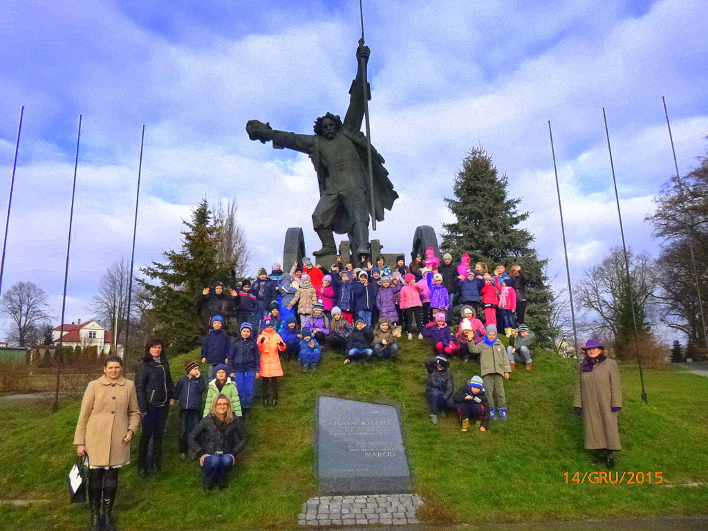 Zdjęcie przedstawia dzieci przy pomniku Bartosza Głowackiego w Racławicach
